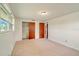 Bedroom with neutral carpet, window, and closet with wood doors at 2616 Bayshore Gardens Pkwy, Bradenton, FL 34207