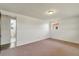 Bedroom with neutral carpet and a window, showing bathroom entrance at 2616 Bayshore Gardens Pkwy, Bradenton, FL 34207