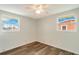 Bedroom with two windows, new vinyl flooring and a ceiling fan at 2616 Bayshore Gardens Pkwy, Bradenton, FL 34207