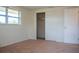 Bright bedroom features a window, closet, and adjacent door for easy access and convenience at 2616 Bayshore Gardens Pkwy, Bradenton, FL 34207