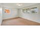 Spacious bedroom with neutral carpeting and ample natural light from multiple windows at 2616 Bayshore Gardens Pkwy, Bradenton, FL 34207
