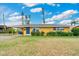 Charming single-story home featuring a well-maintained lawn, colorful exterior, and a cozy carport at 2616 Bayshore Gardens Pkwy, Bradenton, FL 34207