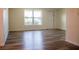 Bright and airy living room boasts updated flooring and a large window, perfect for relaxing or entertaining at 2616 Bayshore Gardens Pkwy, Bradenton, FL 34207