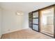 Spacious room showcasing a barn-style sliding door, carpet, and a modern air conditioning unit at 2616 Bayshore Gardens Pkwy, Bradenton, FL 34207