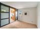 Cozy room featuring carpet and a sliding barn door to the kitchen, adding rustic charm and functionality at 2616 Bayshore Gardens Pkwy, Bradenton, FL 34207