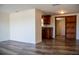 Open living space with wood floors flowing into a kitchen with custom cabinets and granite counters at 2616 Bayshore Gardens Pkwy, Bradenton, FL 34207