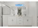 Modern bathroom with double sink vanity, large mirror, and subway tile shower at 2945 Cascabel Ter, North Port, FL 34286