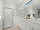Modern bathroom with double sink vanity, large mirror, and subway tile shower at 2945 Cascabel Ter, North Port, FL 34286
