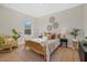 Comfortable bedroom with a wooden bed frame, decorative pillows, and natural light from the window at 2945 Cascabel Ter, North Port, FL 34286