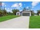 Beautiful single-story home with a long driveway leading to an attached two-car garage at 2945 Cascabel Ter, North Port, FL 34286
