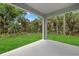 Covered patio overlooking a lush green backyard with mature trees at 2945 Cascabel Ter, North Port, FL 34286