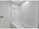 Bathroom with tiled shower and tub combo featuring a white color scheme and updated fixture at 623 Sandy Creek Dr, Brandon, FL 33511