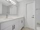 Modern bathroom featuring a bright vanity, large mirror, and neutral wall and door colors at 623 Sandy Creek Dr, Brandon, FL 33511