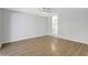 Spacious bedroom with wood-look flooring and ceiling fan with bathroom visible through doorway at 623 Sandy Creek Dr, Brandon, FL 33511