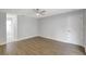 Bright bedroom with wood-look flooring adjacent to bathroom with tiled floors at 623 Sandy Creek Dr, Brandon, FL 33511
