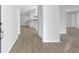 Entryway of a bright home with stylish floors and a view of the kitchen area at 623 Sandy Creek Dr, Brandon, FL 33511