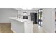 Modern kitchen featuring white cabinets, breakfast bar, updated appliances, and a sliding glass door at 623 Sandy Creek Dr, Brandon, FL 33511