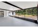 Enclosed patio leading to a back yard with a lush line of trees and green space at 623 Sandy Creek Dr, Brandon, FL 33511