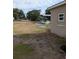 A view of the exterior, with a car and shed in the background at 1609 W Maki Rd, Plant City, FL 33566