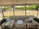 Relaxing screened back porch featuring neutral furniture and a view of the spacious backyard at 13122 Cumberland Dr, Largo, FL 33773