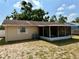 Back exterior view of the house showcasing screened-in lanai at 13122 Cumberland Dr, Largo, FL 33773
