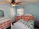Bedroom features coral and white accents, wood-look floors, and plenty of natural light at 13122 Cumberland Dr, Largo, FL 33773