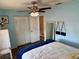 This bedroom features light blue walls and matching closets at 13122 Cumberland Dr, Largo, FL 33773