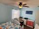 Comfortable bedroom with a ceiling fan, a window and a decorative color scheme at 13122 Cumberland Dr, Largo, FL 33773