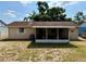 Exterior view of the home's back porch and the large, sunny backyard at 13122 Cumberland Dr, Largo, FL 33773