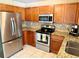 Updated kitchen with stainless steel appliances, granite countertops, and ample cabinet space at 13122 Cumberland Dr, Largo, FL 33773