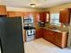 Modern kitchen with stainless steel appliances, granite countertops, and abundant cabinet storage at 13122 Cumberland Dr, Largo, FL 33773