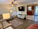 Bright living room with hardwood floors, a ceiling fan, and an open layout to the kitchen at 13122 Cumberland Dr, Largo, FL 33773