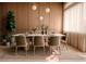 Stylish dining room with a modern table, six chairs, wood accents, and ample natural light at 16491 Hillsborough Blvd, Port Charlotte, FL 33954
