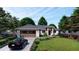 Stunning one-story home featuring a well-manicured front yard and a dark colored car parked in front at 16491 Hillsborough Blvd, Port Charlotte, FL 33954
