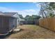 View of the backyard with wood fence and screen patio at 1904 Crown Park Dr, Valrico, FL 33594