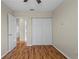 A bright bedroom boasts beautiful wood floors and a closet for storage at 1904 Crown Park Dr, Valrico, FL 33594
