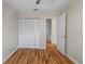 A well-lit bedroom features wood floors and a closet with bi-fold doors, offering ample storage space at 1904 Crown Park Dr, Valrico, FL 33594