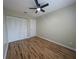 Spacious bedroom features hardwood floors, ceiling fan, and closet, offering a bright and comfortable living space at 1904 Crown Park Dr, Valrico, FL 33594