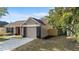 A charming single-Gathering home has a two-car garage, a landscaped yard, and a covered front porch at 1904 Crown Park Dr, Valrico, FL 33594