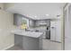 Well-lit kitchen featuring gray cabinets, modern appliances, and ample counter space for cooking at 1904 Crown Park Dr, Valrico, FL 33594