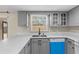 Modern kitchen showcasing light gray cabinets, updated appliances, and a window over the sink at 1904 Crown Park Dr, Valrico, FL 33594