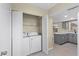 Convenient laundry room featuring a washer and dryer inside closet at 1904 Crown Park Dr, Valrico, FL 33594