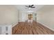 Open-concept living area with stylish hardwood flooring, ceiling fan, and sliding glass doors to the backyard at 1904 Crown Park Dr, Valrico, FL 33594