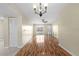 Bright, open living room featuring wood floors, modern lighting, and neutral walls at 1904 Crown Park Dr, Valrico, FL 33594