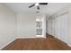 A main bedroom features wood floors, a ceiling fan, and closet space leading to an attached bathroom at 1904 Crown Park Dr, Valrico, FL 33594