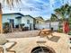 Spacious backyard featuring a brick-paved patio, picnic table, and string lights, ideal for outdoor entertaining at 2904 Sanchez St, Tampa, FL 33605