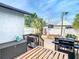 Multi-level back deck with a grill, outdoor seating, and a view of the brick-paved patio, ideal for outdoor living at 2904 Sanchez St, Tampa, FL 33605