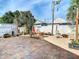 Expansive brick-paved backyard with outdoor seating, a picnic table, and lush landscaping, great for gatherings at 2904 Sanchez St, Tampa, FL 33605