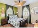 Bedroom with ceiling fan, tropical bedding, and hardwood floors at 2904 Sanchez St, Tampa, FL 33605