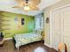 Bedroom features a tropical-themed bedspread, ceiling fan, and modern decor accents at 2904 Sanchez St, Tampa, FL 33605